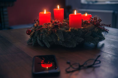 Close-up of illuminated candles on table