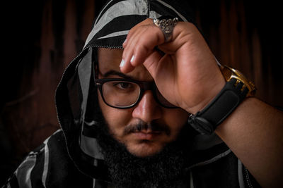 Portrait of man wearing eyeglasses and hood clothing