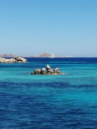 Scenic view of sea against clear blue sky