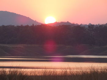 Scenic view of sunset over field