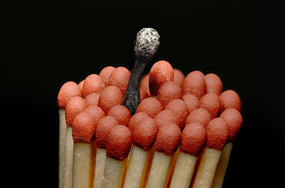 Close-up of matchsticks against black background