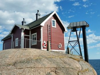 Exterior of building by sea against sky