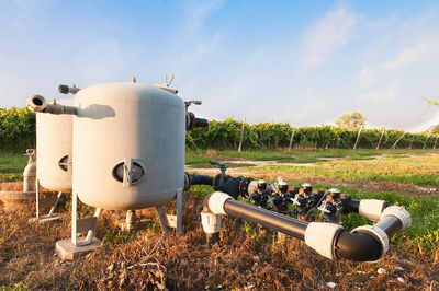 Agricultural machinery on field against sky