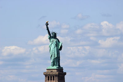 Low angle view of statue against cloudy sky