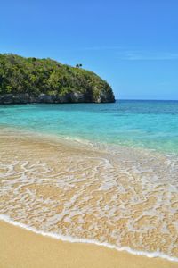 Scenic view of sea against clear blue sky
