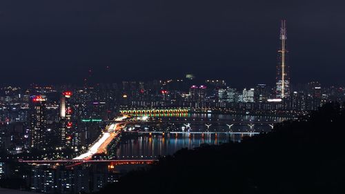 High angle view of illuminated buildings in city at night