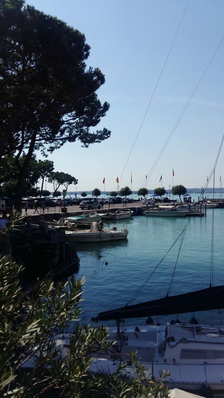 BOATS MOORED AT HARBOR