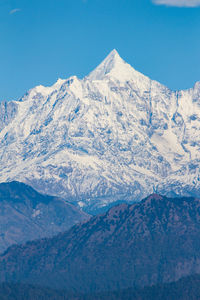 Scenic view of snowcapped mountains against clear sky