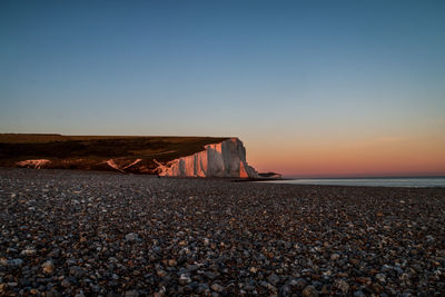 Scenic view of sea against clear sky during sunset