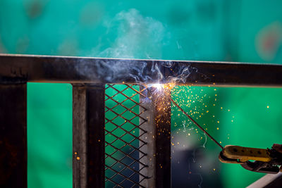 Close-up of illuminated lighting equipment on barbecue grill