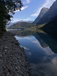 Scenic view of lake and mountains against sky