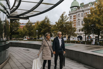 Couple walking in city with shopping bags