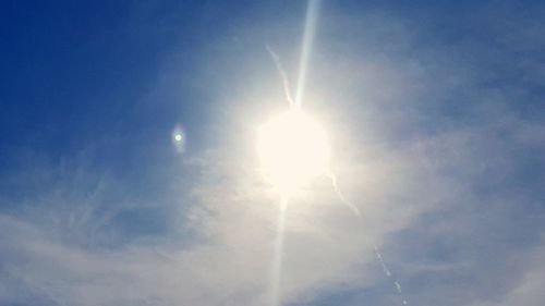 Low angle view of vapor trail against blue sky