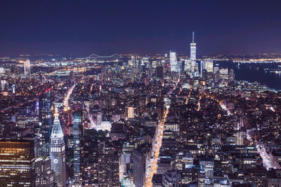 Illuminated cityscape against sky at night