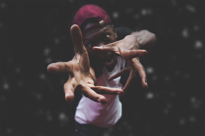 Midsection of man standing against black background