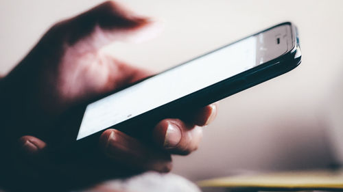 Close-up of hand holding mobile phone