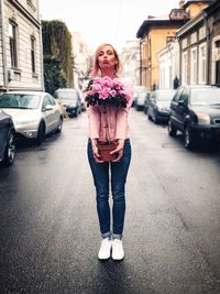 Full length of woman standing on street in city