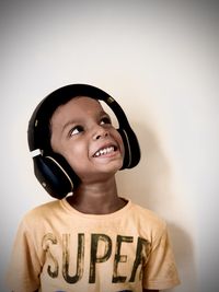 Portrait of smiling boy against wall