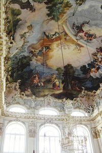 Low angle view of chandelier hanging from ceiling in building