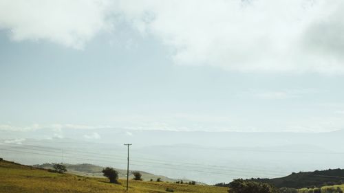 Scenic view of landscape against cloudy sky