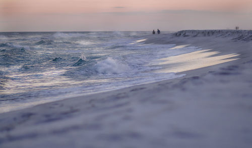 Close-up of wave on beach against sky