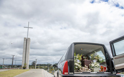 Closeup shot of a funeral casket or coffin in a hearse or chapel or burial at cemetery
