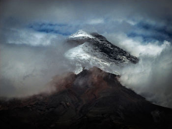 Smoke emitting from volcanic mountain against sky