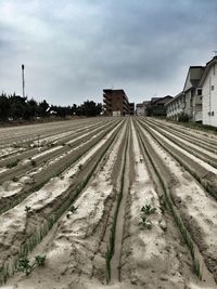 Railroad track against cloudy sky