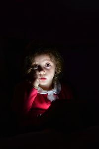 Close-up of cute girl in darkroom