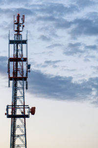 Low angle view of communications tower against sky