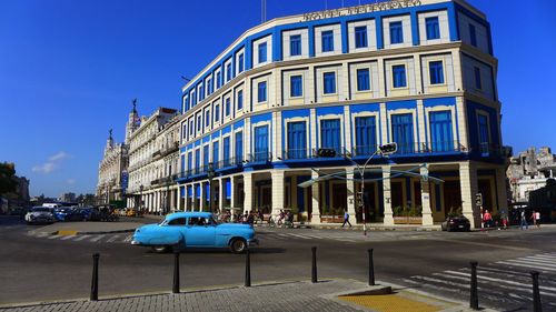 Blue car on city street