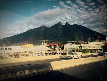 Mountain range against cloudy sky