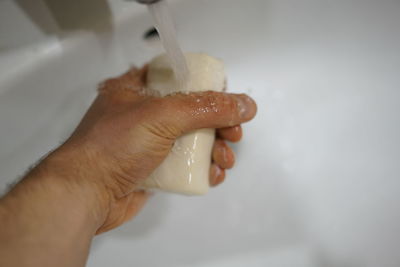 Close-up of hand holding ice cream cone