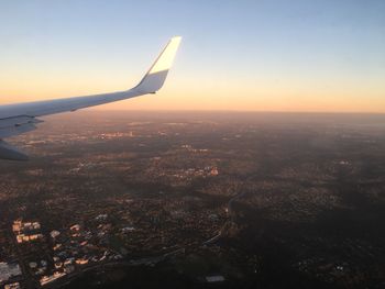 Aerial view of cityscape against sky during sunset