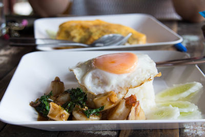Close-up of fried egg with calamari in plate on table