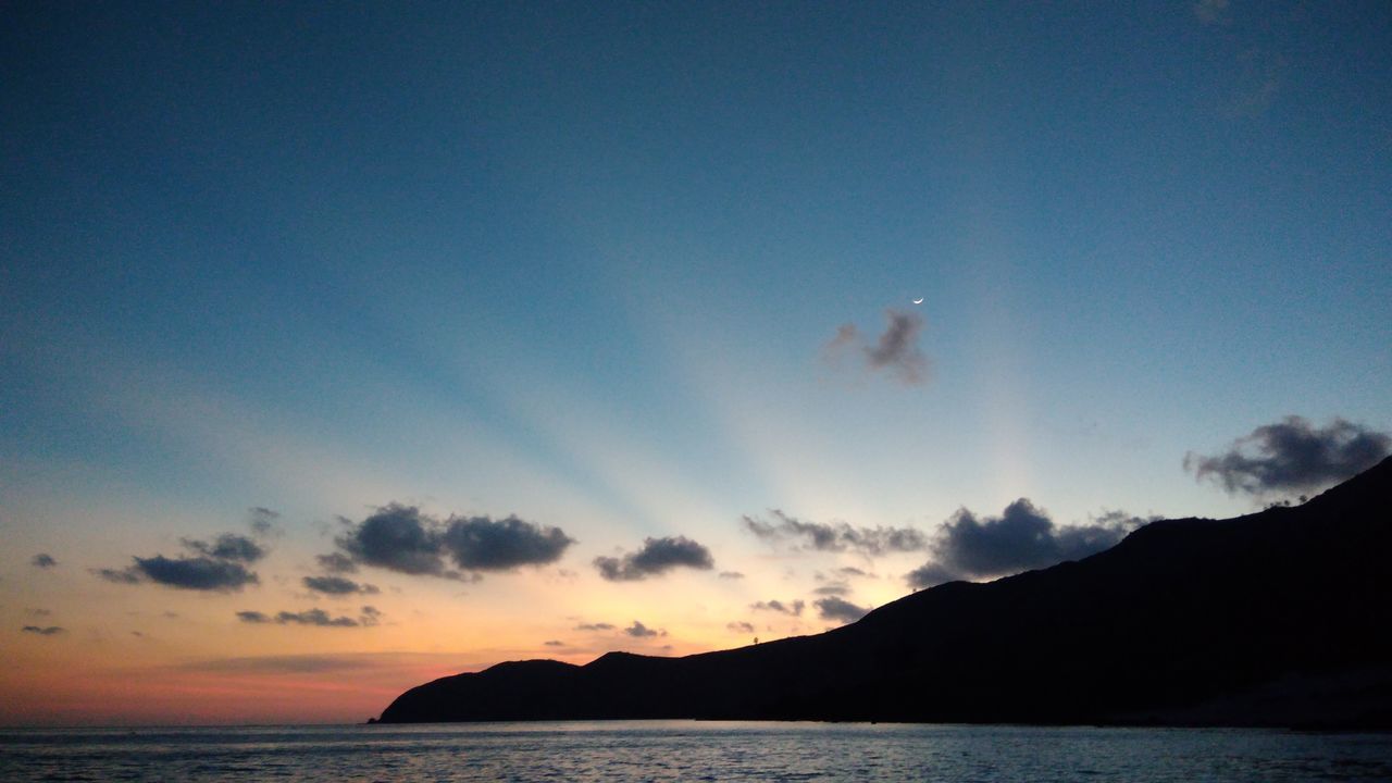 sky, scenics, sea, tranquil scene, nature, sunset, beauty in nature, tranquility, silhouette, cloud - sky, water, mountain, no people, blue, outdoors, horizon over water, day