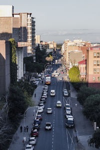 High angle view of traffic on road amidst buildings in city