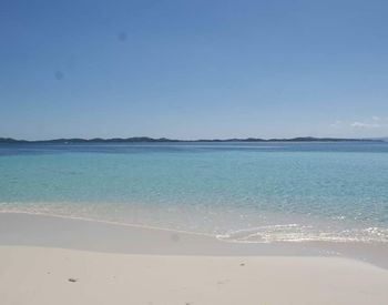 View of beach against blue sky