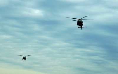 Low angle view of helicopters in sky