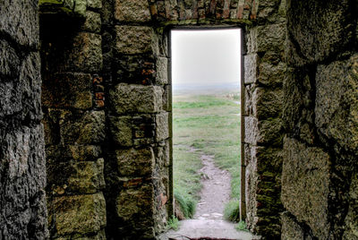 Street amidst buildings seen through window