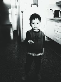 Portrait of boy standing at home