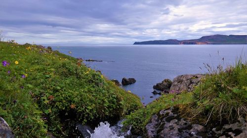 Scenic view of sea against cloudy sky