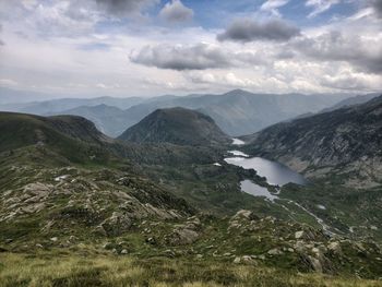 Scenic view of mountains against cloudy sky