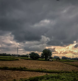 Scenic view of storm clouds over field