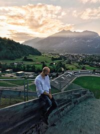 Man looking at mountain against sky