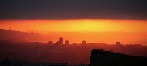 Silhouette of city during sunset
