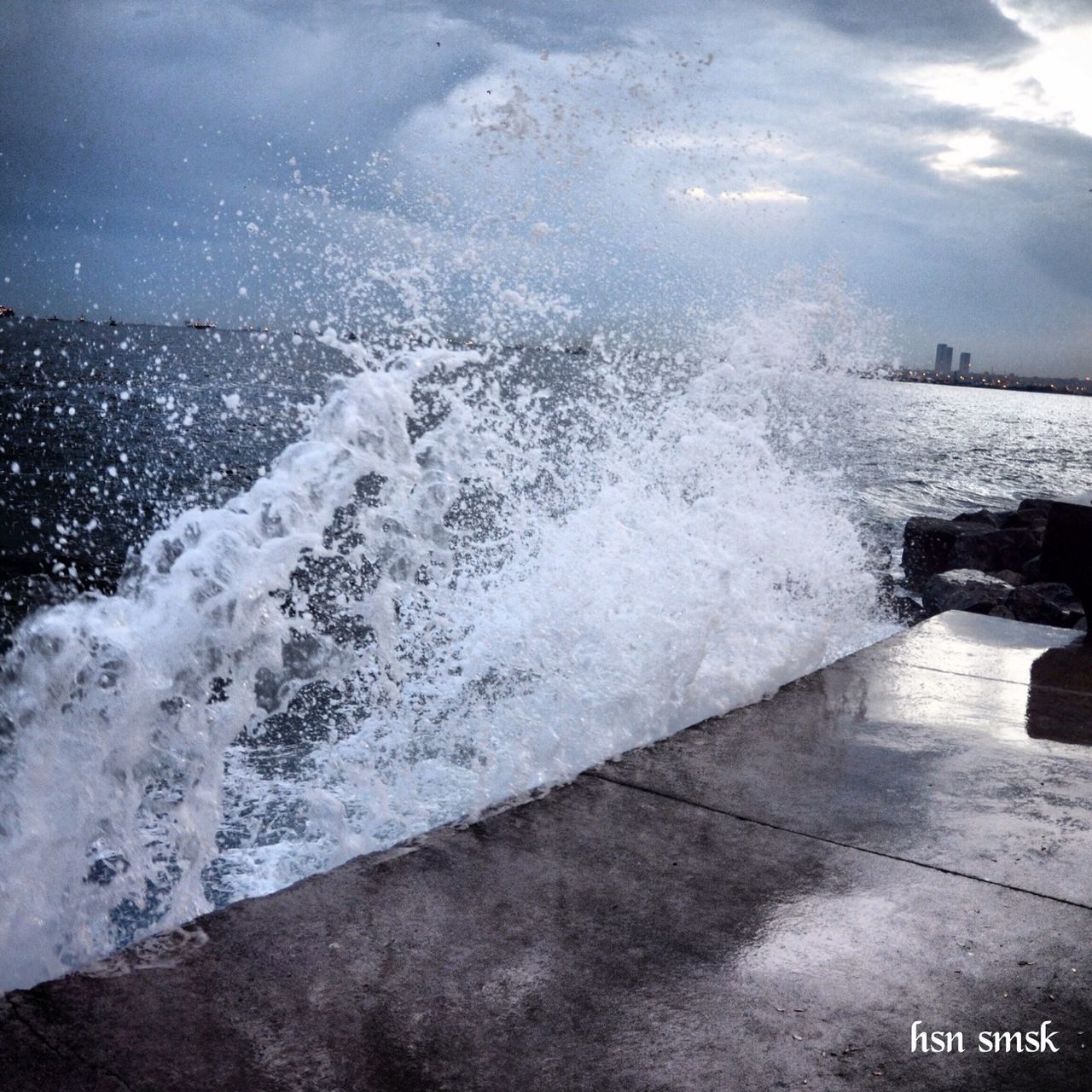 water, sea, surf, wave, splashing, motion, sky, nature, horizon over water, shore, beauty in nature, scenics, high angle view, weather, outdoors, wet, cloud - sky, day, power in nature, built structure