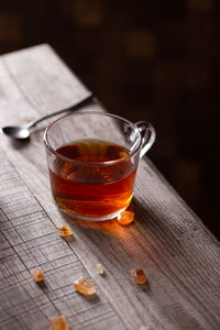 Cup of black tea on a wooden table