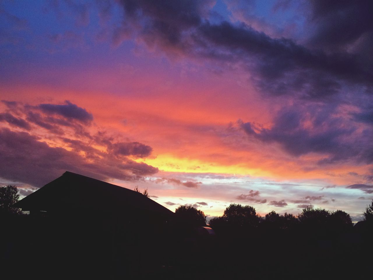 sunset, silhouette, sky, building exterior, architecture, built structure, cloud - sky, orange color, tree, beauty in nature, low angle view, dramatic sky, scenics, house, cloud, nature, cloudy, tranquility, dusk, outdoors