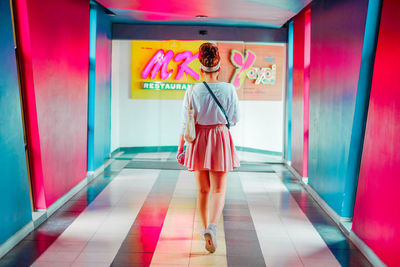 Full length of woman standing in tunnel